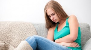 Woman having abdominal pain, upset stomach or menstrual cramps